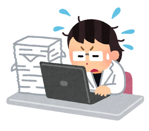 書類の山を前に忙しく働く白衣の女性